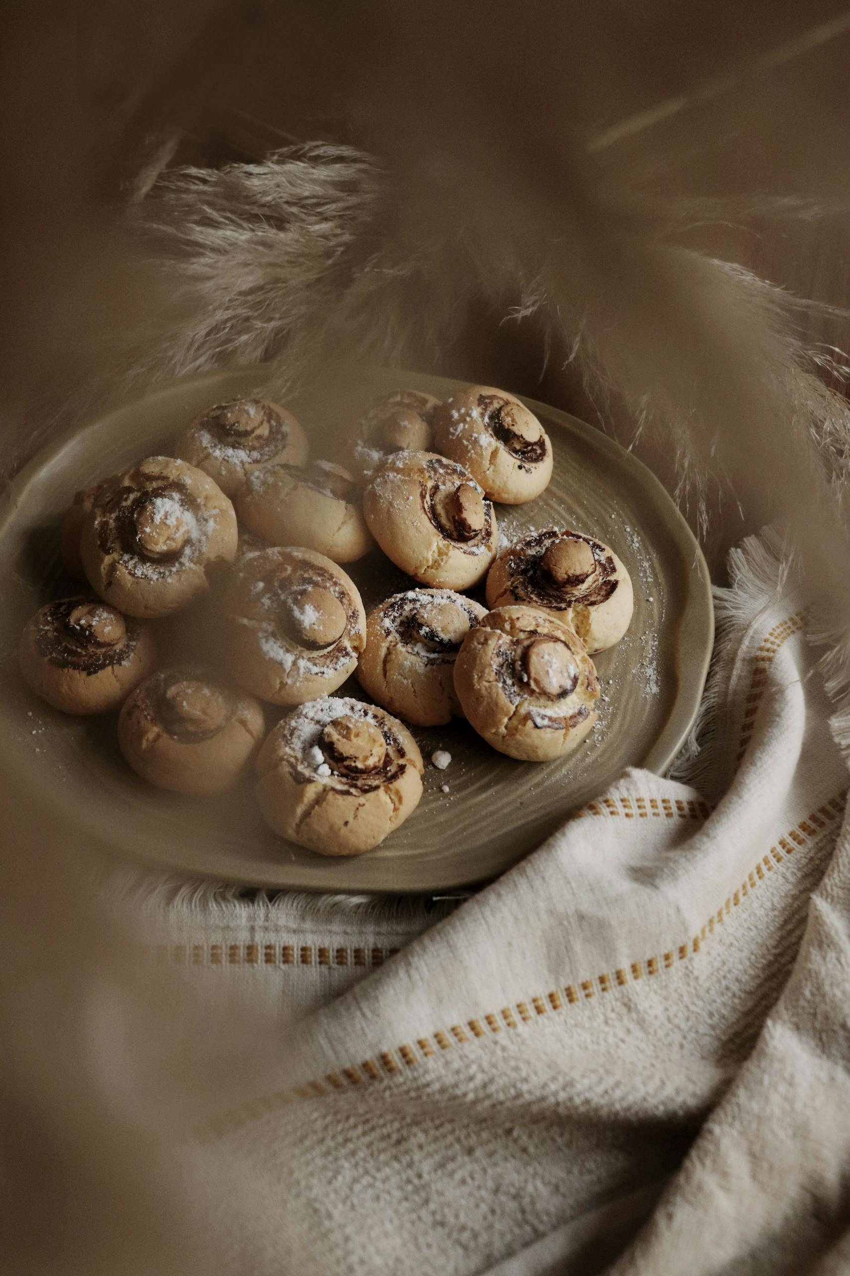 Turkish kurabiye cookies with powdered sugar on a plate surrounded by beige textures.
